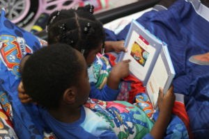Kids reading PJ Time book (overhead view)