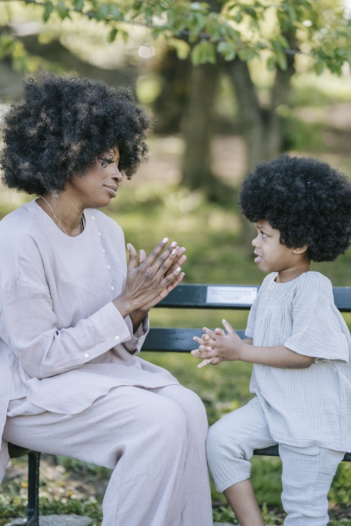 A Woman Sitting on a Wooden Bench with her Daughter